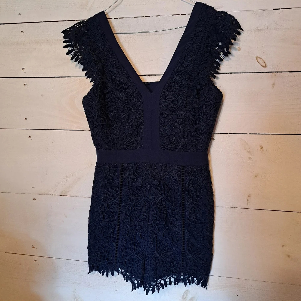 Adelyn Rae navy blue lace romper. Size Medium. Cut out back.